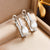 Fashion Droplet Pearl Titanium Steel Electroplating Earrings